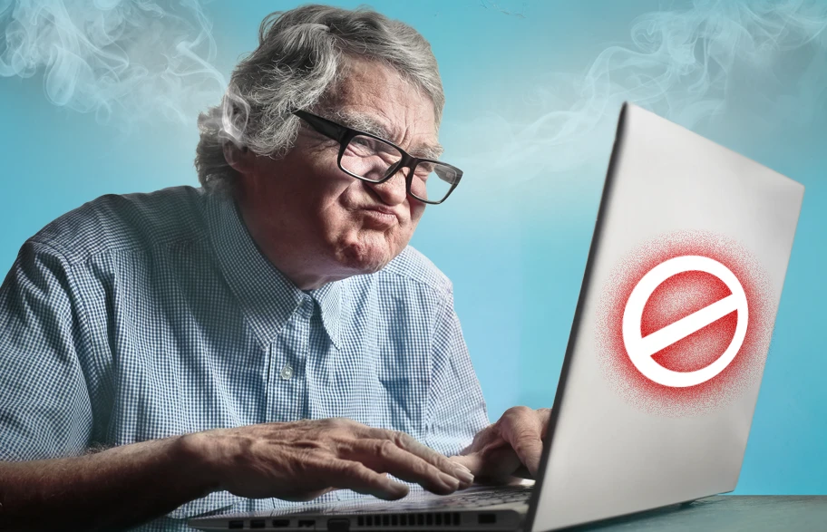 Persona anziana che fatica a usare un computer portatile, simbolo dei problemi di accessibilità web